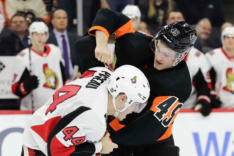 Flyers left winger Joel Farabee throws a punch at Ottawa Senators center Jean-Gabriel Pageau during a December 2019 game.