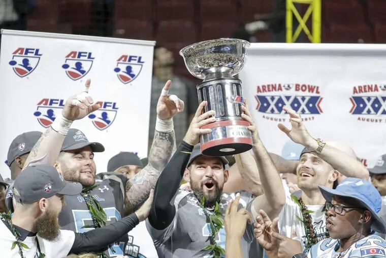 Soul players hold the Arena Bowl 30 Championship trophy after they beat the Tampa Bay Storm last August.