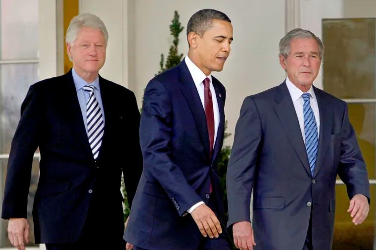 President Barack Obama, center, walks out of the Oval Office of the White House with former Presidents Bill Clinton, left, and George W. Bush, right, to deliver remarks in the Rose Garden at the White House in Washington on Jan. 16, 2010. The three former presidents say they'd be willing to take a coronavirus vaccine publicly, once one becomes available, to encourage all Americans to get inoculated.