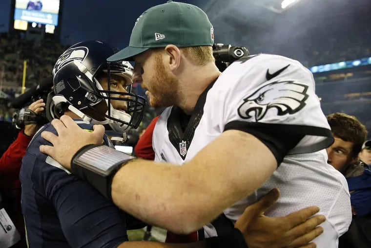 Seahawks’ Russell Wilson, left, and Eagles’ Carson Wentz, right, embrace after the game. Philadelphia Eagles lose 26-15 to the Seattle Seahawks in Seattle, WA on November 20, 2016. DAVID MAIALETTI / Staff Photographer