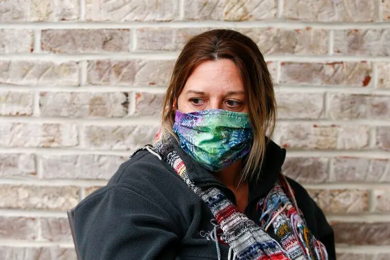Marie Ryan wearing her mask while sitting outside her Berlin Borough, N.J.  home on May 8.  Ryan's brother, Joseph Pearson has tested positive for the COVID19 virus while living at the New Lisbon Developmental Center, a home for people with developmental disabilities in the Pine Barrens.