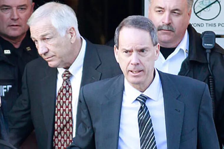 Jerry Sandusky and lawyer Joe Amendola leave the Centre Couty Courthouse on Tuesday. (David Swanson/Staff Photographer)