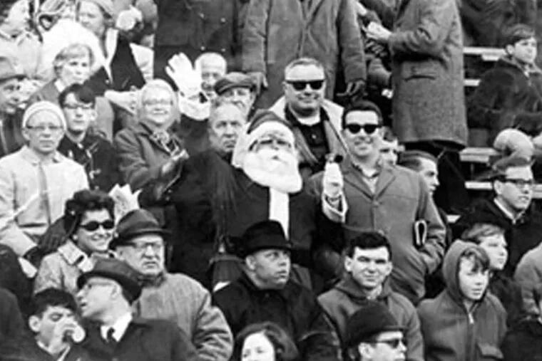 Frank Olivo playing Santa at an Eagles game in 1967, top. He was pelted with snowballs the next year. Right, during a 2008 anniversary event at Lincoln Financial Field.
