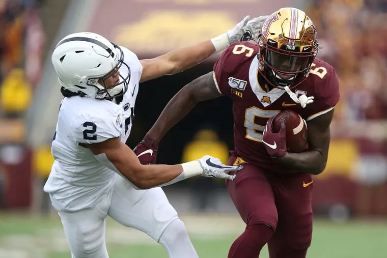 Minnesota wide receiver Tyler Johnson (6) holds onto the ball against Penn State cornerback Keaton Ellis (2) during an NCAA college football game, Saturday, Nov. 9, 2019, in Minneapolis. (AP Photo/Stacy Bengs)