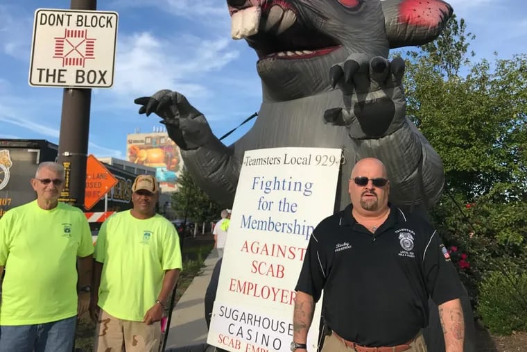 Local 929 president Rocky Bryan Jr. (right) with SugarHouse Casino employees protesting a lack of progress for a collective bargaining contract.