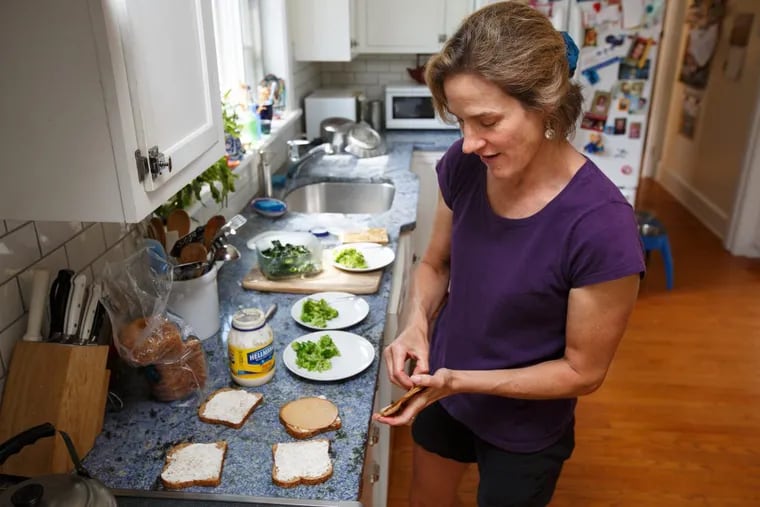 Katy Ruckdeschel fixes a healthy lunch of tofurky sandwiches, broccoli, and kale for her two daughters.