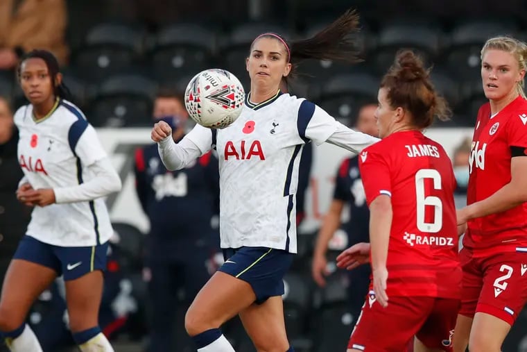 Tottenham Hotspur's Alex Morgan, center, vies for the ball with Reading's Angharad James during the English Women's Super League soccer match between Tottenham Hotspur and Reading at the Hive stadium in London Saturday, Nov. 7, 2020.