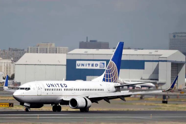 A United Airlines passenger plane lands at Newark Liberty International Airport.