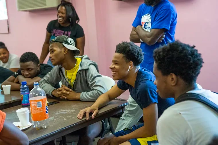 Steven Pierce (center) laughs during the final session of the Youth Empowerment for Advancement Hangout (YEAH) pilot program at the Cobbs Creek Recreation Center on Friday, June 07, 2019. The 14-week program, started by Kendra Van de Water and James Aye, covered a range of issues,  including mental health and relations with police.