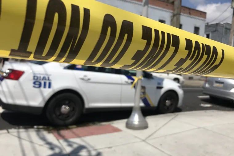 Crime scene tape and a Philadelphia Police car