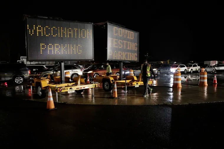 Though omicron may cause milder symptoms for some, experts continue to urge the vaccines, available at sites such as this Gloucester County public works complex in Clayton, N.J.