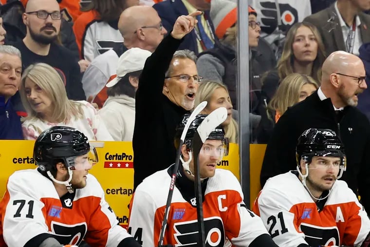 Flyers coach John Tortorella signals to his players during a February game against the Rangers.