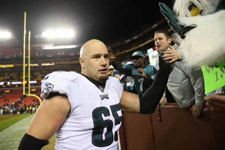 Lane Johnson celebrates with fans after the Eagles beat the Redskins.
