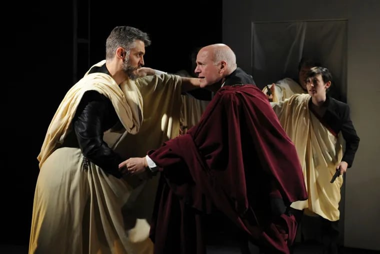 (Left to right:) David Brusasco, Paul Hebron, and Mary Tuomanen in “Julius Caesar,” through April 29 at the Quintessence Theater Company.