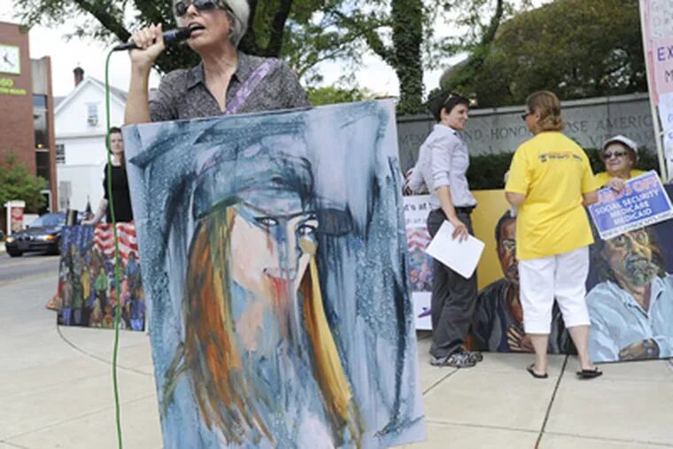Theresa BrownGold displays her portrait of Courtney Leigh Huber and others with medical insurance woes outside the Bucks County Courthouse in Doylestown. (Sharon Gekoski-Kimmel / Staff Photographer)