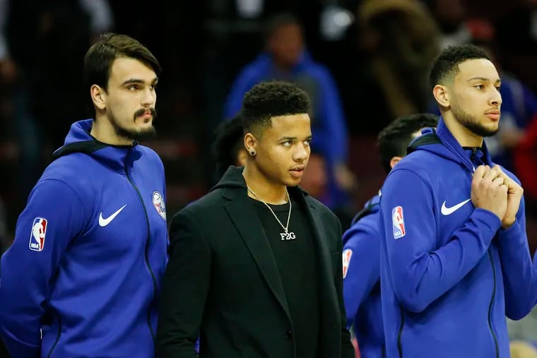 Sixers guard Markelle Fultz on the bench between teammates Dario Saric (left) and Ben Simmons during a game in January.