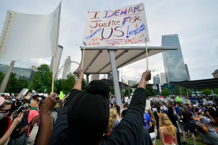 Demonstrators protest in Centennial Olympic Park, Friday, May 29, 2020 in Atlanta. Protests were organized in cities around the United States following the death of George Floyd during an arrest in Minneapolis.