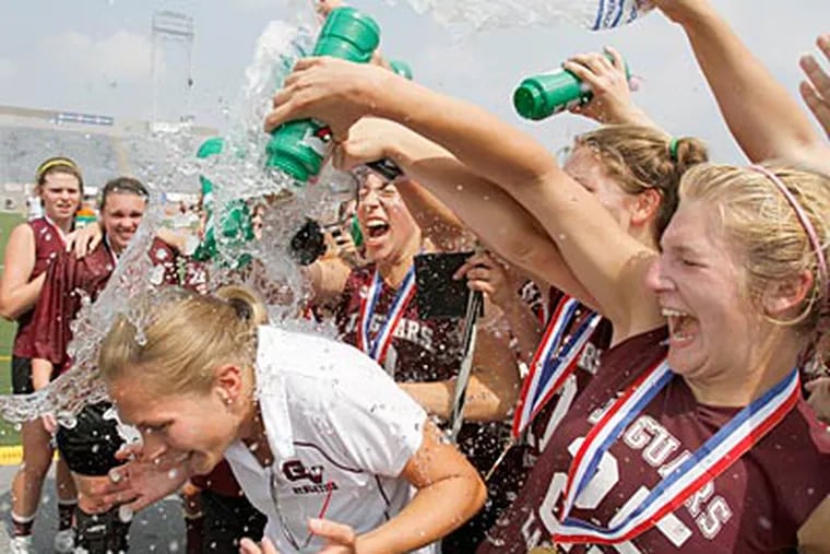 Garnet Valley players dump water on head coach Kate Henwood as they celebrate their victory. (Charles Fox/Staff Photographer)
