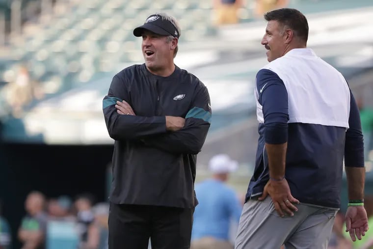 Eagles head coach Doug Pederson, left, and Tennessee Titans head coach Mike Vrabel, right, talk on the field before Thursday's preseason game at Lincoln Financial Field.