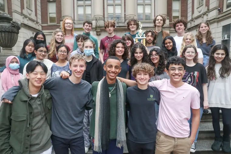 The Masterman debate team poses for a group photo outside of Masterman School in Philadelphia. The team, which is self-coached and self-funded, just scored a big victory at a national tournament, its first such win.