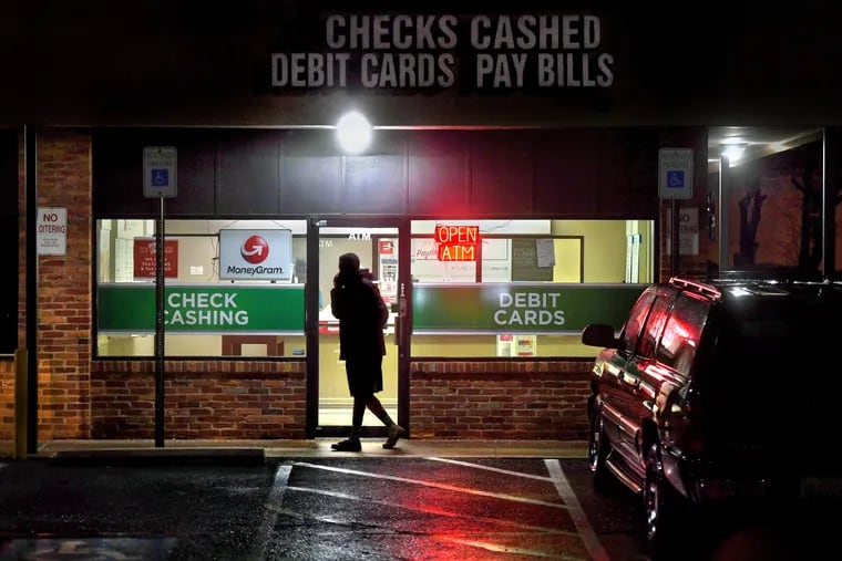 A customer leaves a payday loan store in Gaithersburg, Md. Predatory financial practices like payday lending have contributed to distrust of financial systems among Black Americans, says Jason Ray of Philadelphia's Zenith Wealth Partners.