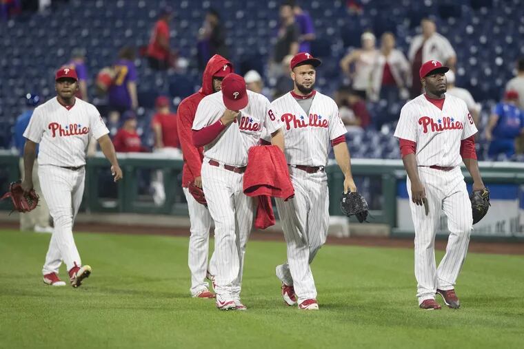 Several of the Phillies relief pitchers walk off the field from the bullpen after Wednesday's loss to the Nationals.