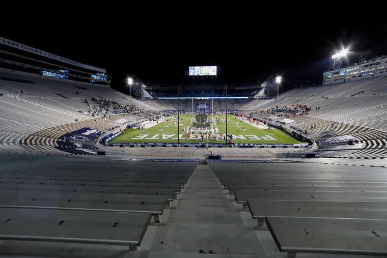 Ohio State players warm up before a football game against Penn State in a nearly empty Beaver Stadium.