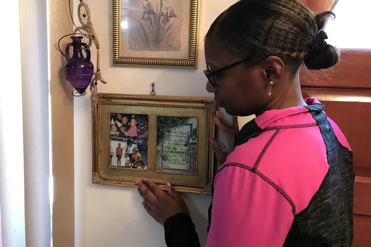 Kristi Richardson looks at photos of her husband, Michael Richardson, at her home on Friday, March 15, 2019.