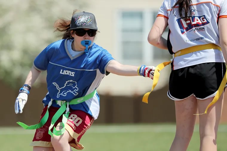 Nia Barley reaches for a flag during a flag football game at Lansdale Catholic High School in on April 24. Barley plays flag football to empower herself as she battles a degenerative eye disease.