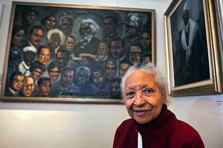 Willingboro resident Lady Bird Strickland, who was born into poverty in the foothills of Georgia and for more than six decades has painted aspects of African American life, sits with some of her paintings on display at Warden House in Mt. Holly. ( RON TARVER / Staff Photographer )