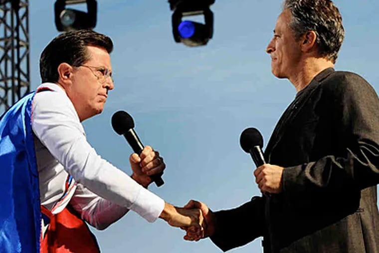 Comedians Stephen Colbert (left) and Jon Stewart draw thousands to a rally in D.C. for sanity (or fear). (OLIVIER DOULIERY / Abaca Press)