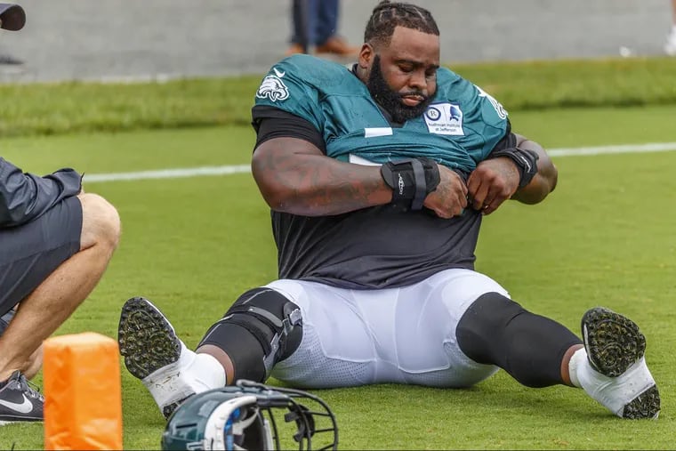 Eagles offensive lineman Jason Peters secures his uniform jersey prior to his stretching session during warmups on Sunday August 19, 2018, at the NovaCare Center. MICHAEL BRYANT / Staff Photographer