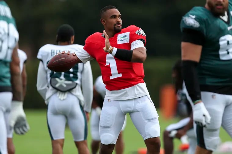Eagles quarterback Jalen Hurts (1) warms up during a joint practice with the New England Patriots.