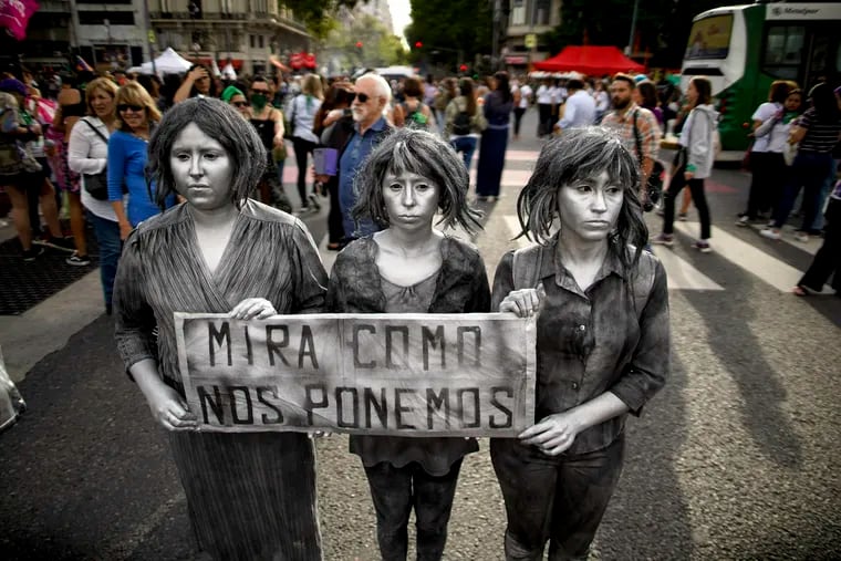 A trio of women hold a sign with a message that reads in Spanish: "See how we end up," during a demonstration commemorating International Women's Day, in Buenos Aires, Argentina, Friday, March 8, 2019.