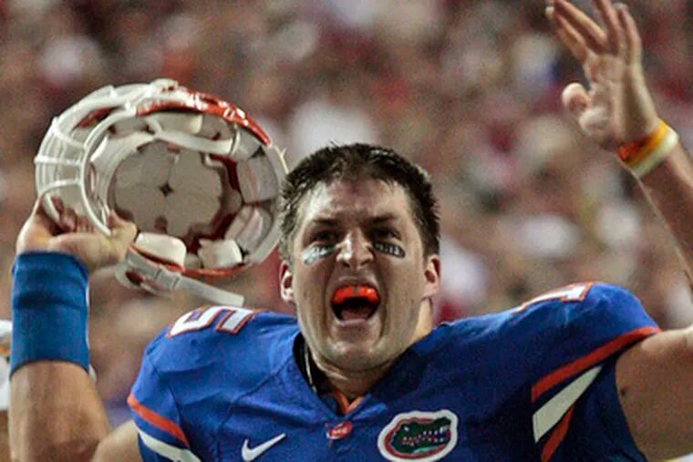 Florida&#0039;s Tim Tebow revs up the crowd near the end of a win over Alabama that put the Gators in the BCS title game.