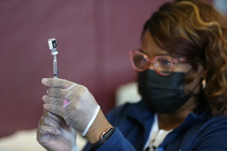 Registered nurse Melly Warren extracts the COVID-19 vaccine out of a vial at Tabernacle Baptist Church in Burlington, N.J. on March 21, 2021.