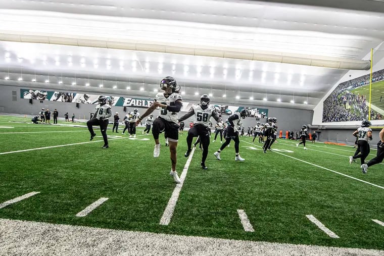 Eagles players warm up during practice at the NovaCare Complex in South Philadelphia on Wednesday.