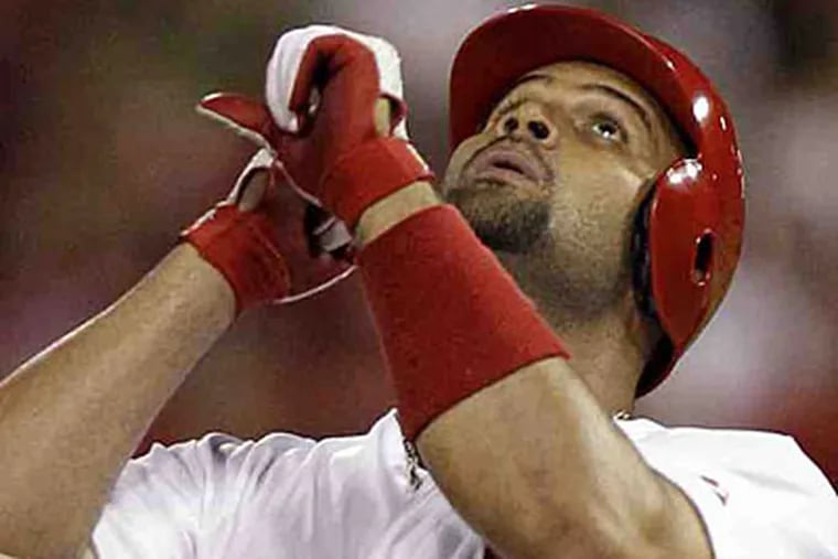 First baseman Albert Pujols appears to be seeking divine intervention on a new contract with St. Louis. (Jeff Roberson/AP)