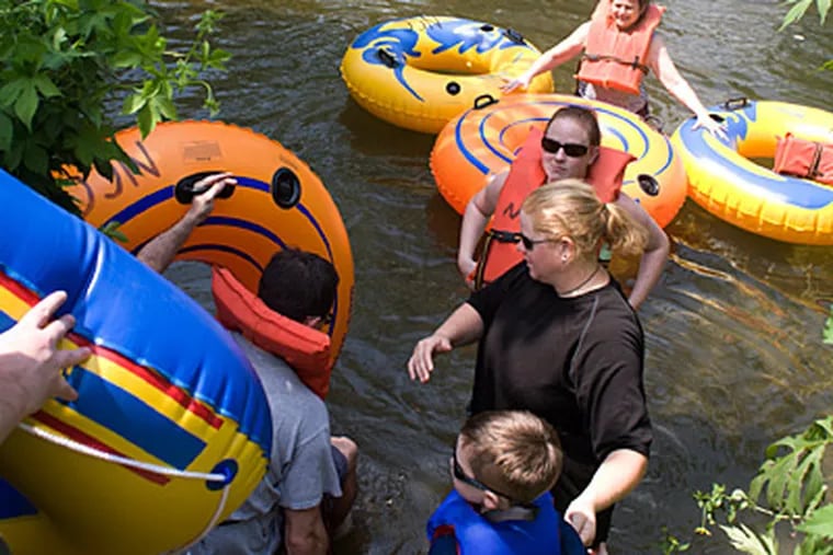 As the heatwave continues to bake the region, a long line of tubers heads into the Brandywine River near Pocopson, Delaware County , for an afternoon of fun on Saturday. (Ed Hille / Staff Photographer)