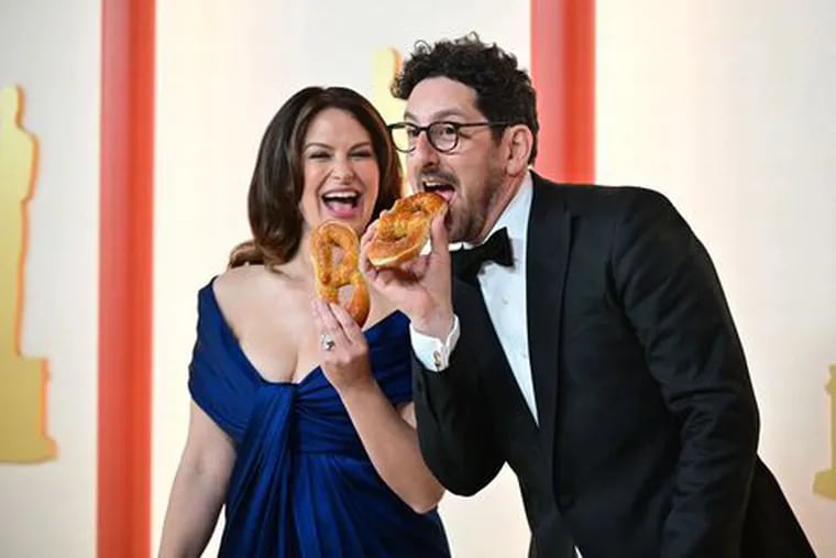 Actors Adam Shapiro and Katie Lowes with Shappy Philly pretzels at the Oscars red carpet.
