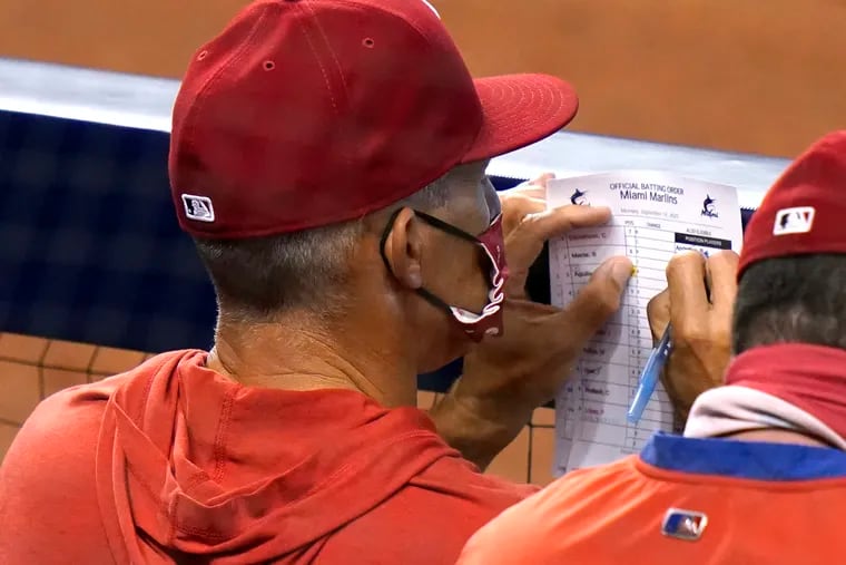 Phillies manager Joe Girardi looks at his lineup card during his team's loss to the Marlins on Monday in Miami.