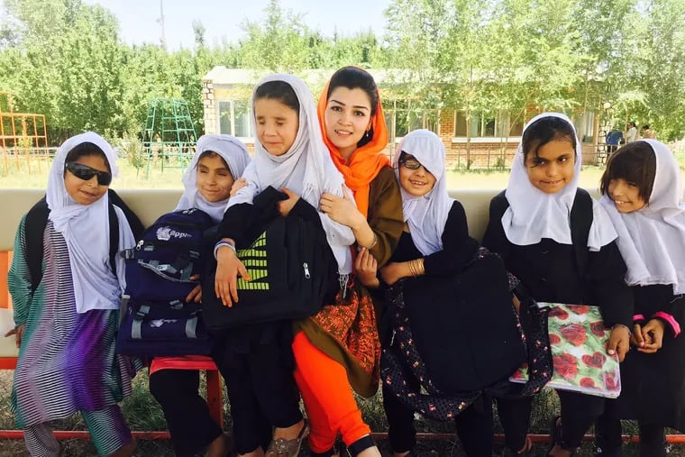 Yasameen Mohammadi, part of the new generation of educated Afghan women, meets with students from the Kabul School for the Blind, where she set up a braille library.