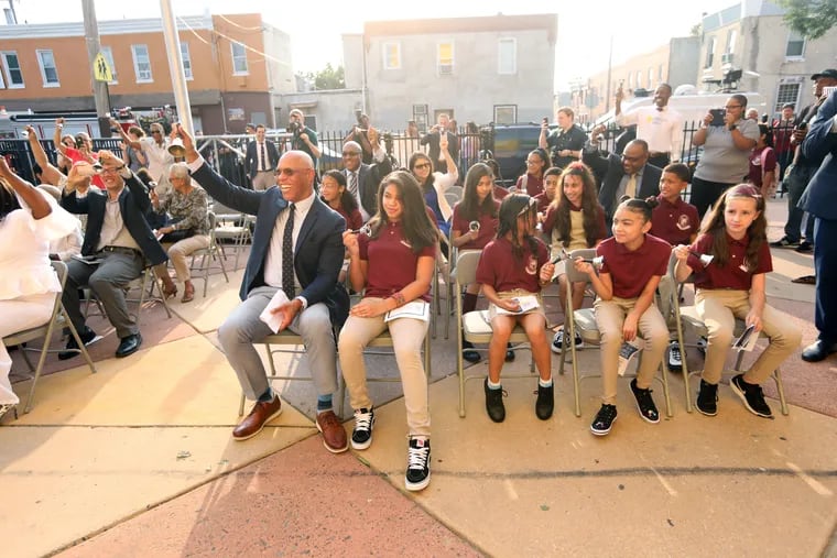 Dr. William R. Hite, Superintendent for the School District of Philadelphia helps ring in the new year on the first day of school with (L-R) Angelys Roman, Jarhaim Munoz, Marianna Rodriguez, and Annika Pfeister at the Luis Munoz-Marin School in Philadelphia, Pa., Aug. 27, 2018.