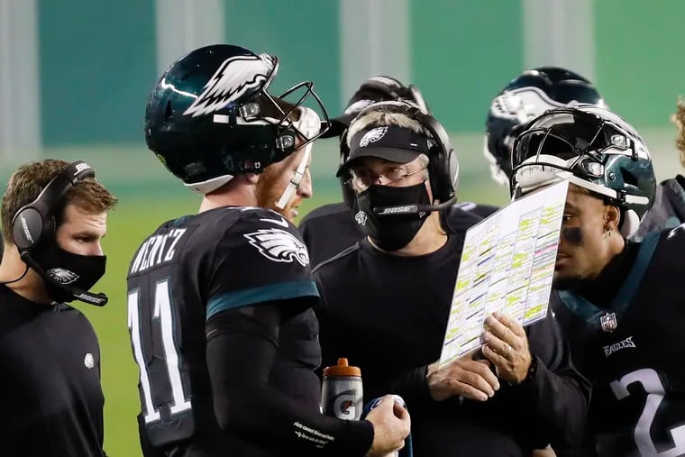 Eagles Head coach Doug Pederson and quarterback Carson Wentz looking over a play on their final drive late in the fourth quarter against the New York Giants on Thursday, October 22, 2020.