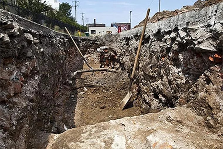 A large trench dug in a parking lot at Columbus Boulevard and Vine Street shows walls believed to be from the 19th-century West Shipyard. (Elise Wrabetz / Staff Photographer)