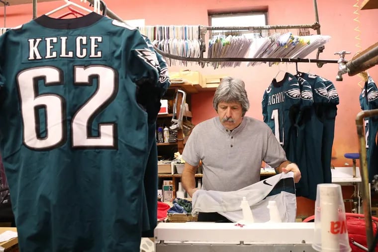 Joe Lattanzio, co-owner of Lattanzio’s Linn Cleaners, works on cleaning the Eagles’ uniforms at his South Philadelphia shop.