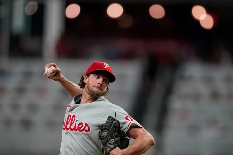 Phillies starting pitcher Aaron Nola throws a pitch in the third inning against the Braves on Saturday at Truist Park.