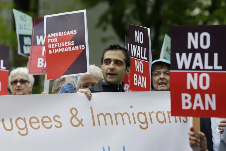 Protesters hold signs during a demonstration against President Donald Trump's revised travel ban outside a federal courthouse in Seattle last month.