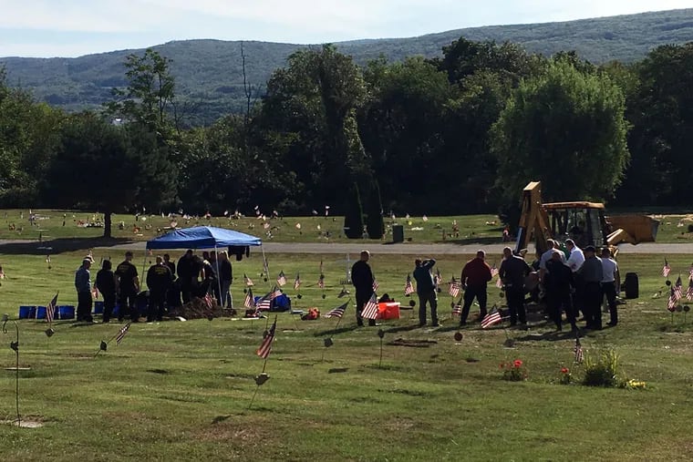 In Wilkes-Barre, Pennsylvania state police exhume the bodies of three unidentified homicide victims.