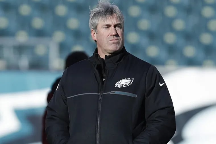 Philadelphia Eagles head coach Doug Pederson watches his team warm up before Saturday’s playoff game against the Atlanta Falcons at Lincoln Financial Field.